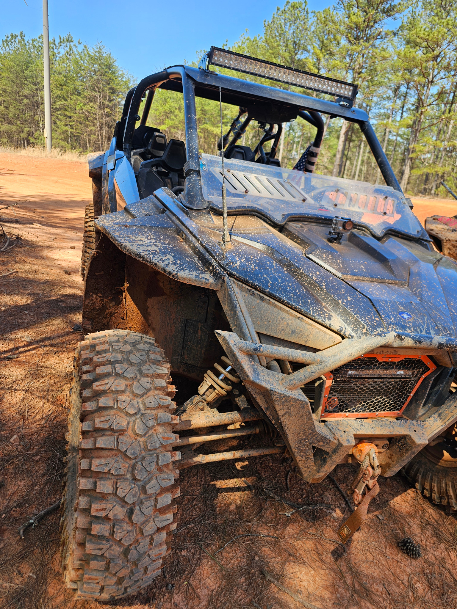 Two muddy side by sides on trail